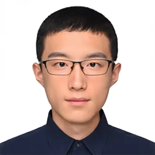 A headshot of Shaozhi Wang standing in front of a white background.