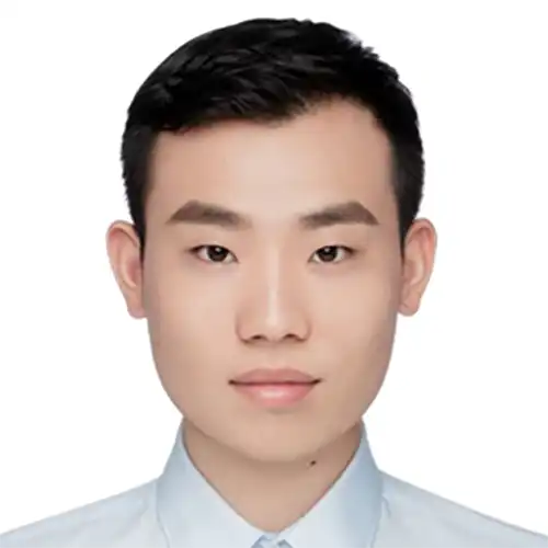 A headshot of Zhengming Zhang standing in front of a white background.