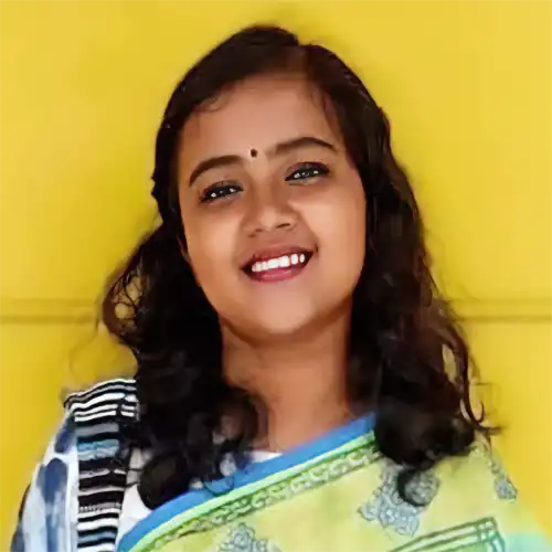 A headshot of Faria Armin standing in front of a yellow wall.