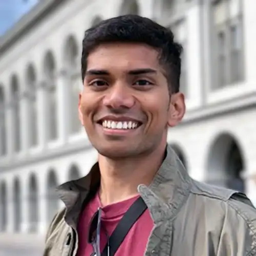 A headshot of Kumar Apurv standing in front of a building.