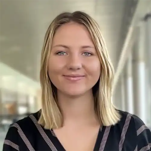 A headshot of Morgan Stutzman standing in a business office.