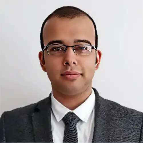 A headshot of Siddant Betrabet standing in front of a white background.