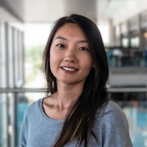 A headshot of Tina Chen standing in a business office.