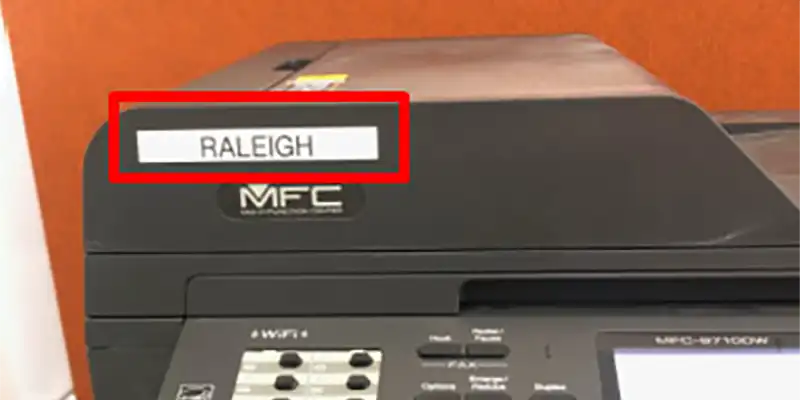 A printer with a red box around the name of the printer.