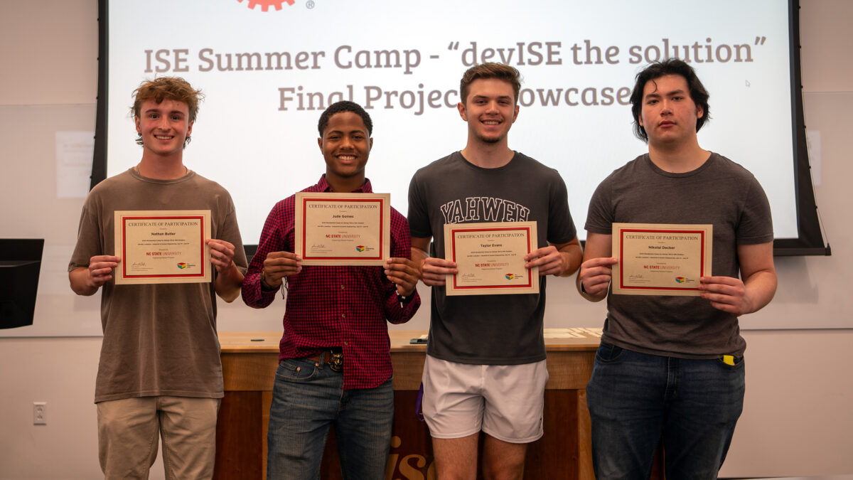 Team #1 showing off their summer camp certificates.