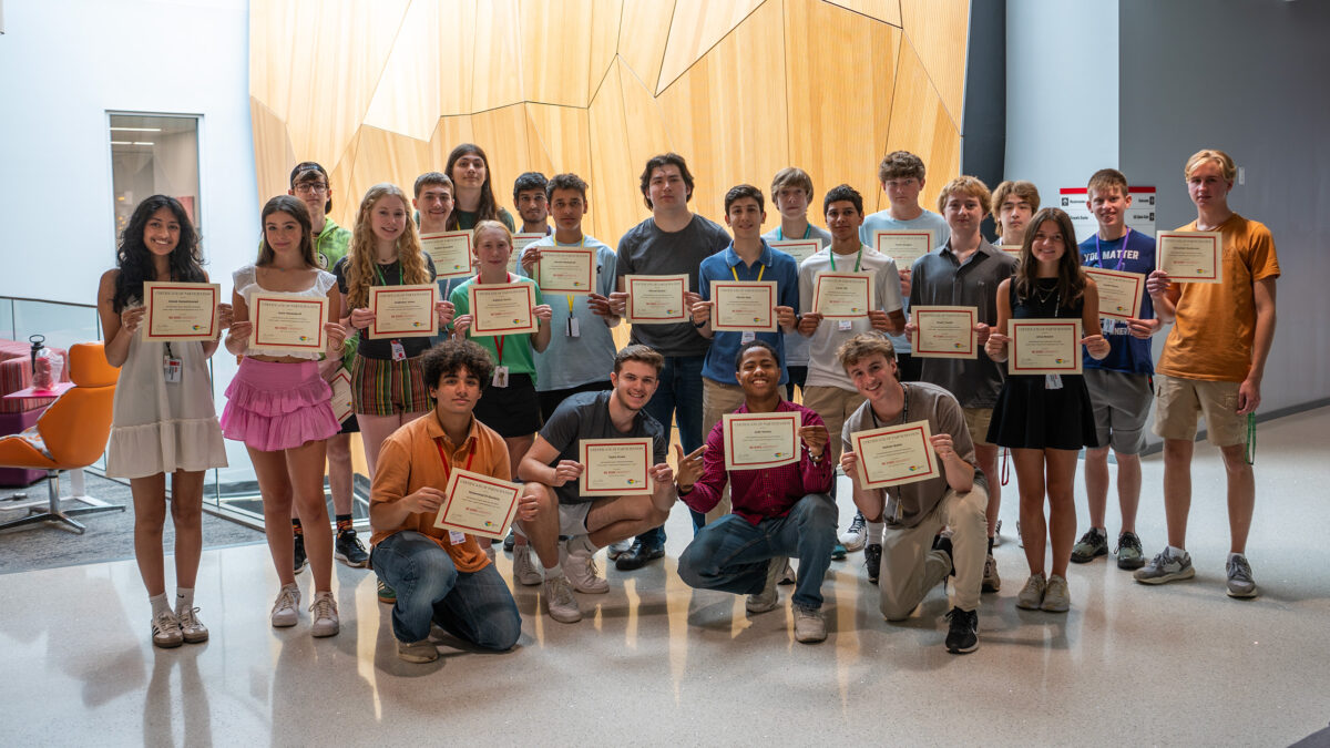 Summer campers posing with their certificates.