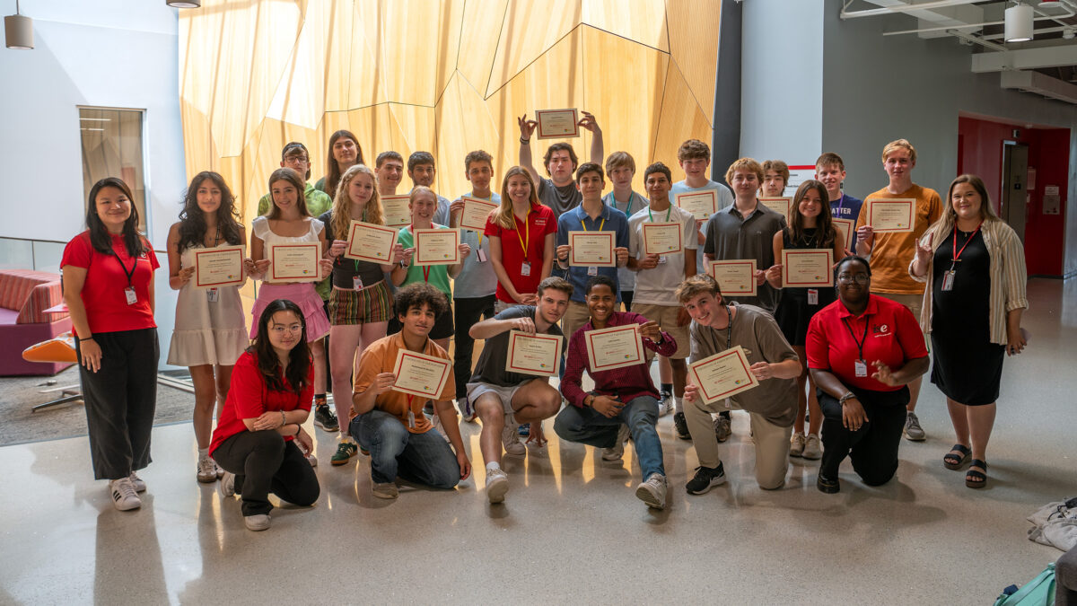 Summer campers, staff and student helpers posing with their certificates.