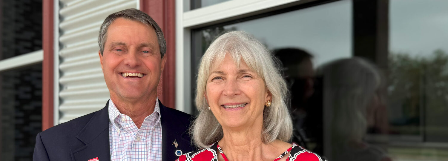 George and Grace Auten standing together outside of their company's building.