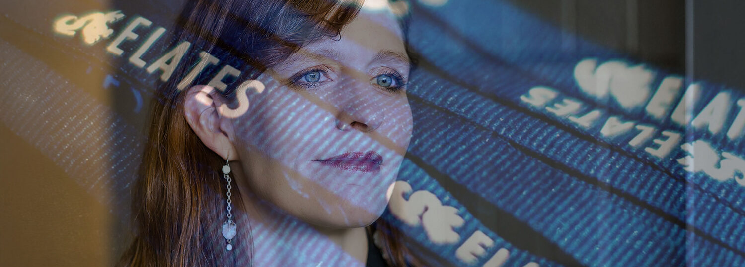 A headshot of Julie Swann covered by an extremely transparent image of the words ELATES.