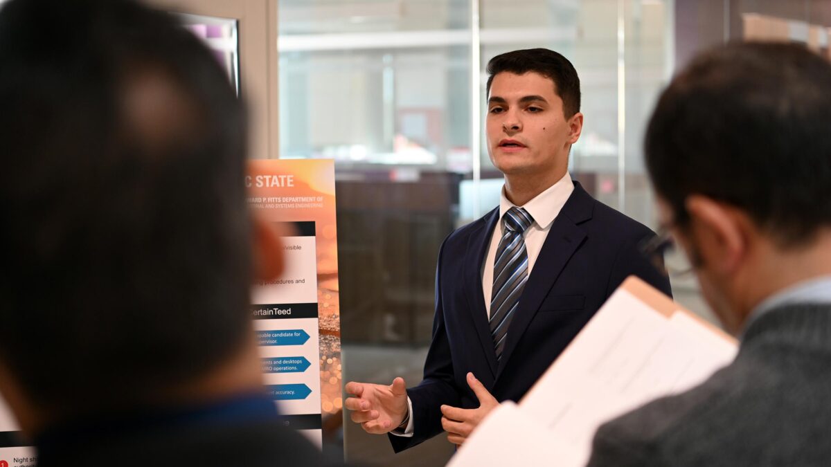 Gregg Pisculli  of Team St. Gobain presenting his part of the project to the judges.