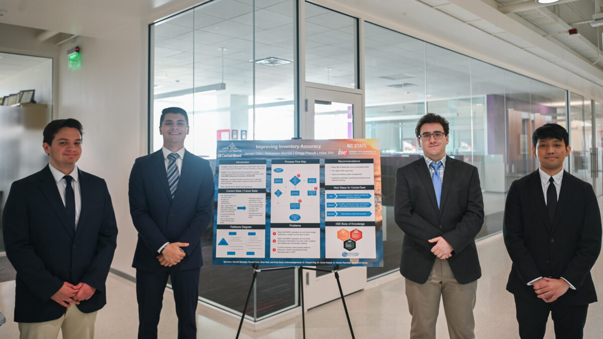 Team Saint Gobain stands next to their senior design poster