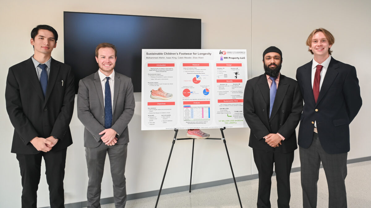 Team MR Property LLC stands next to their senior design poster