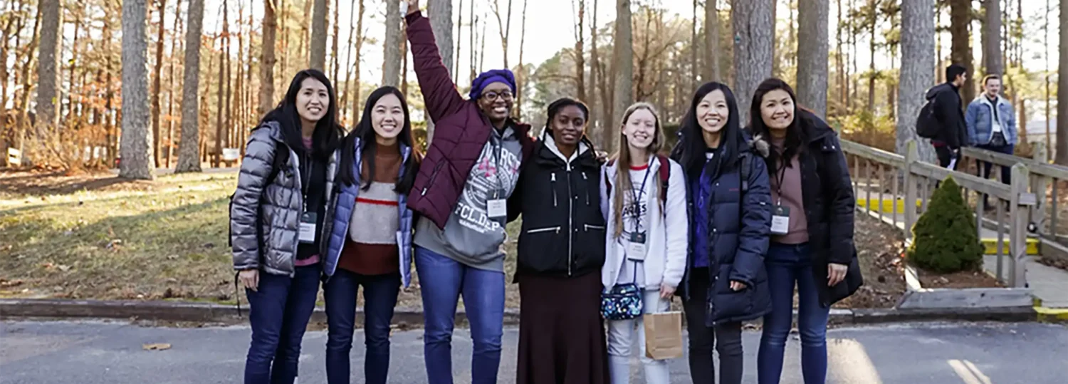 Tabitha Gardner standing in the middle of six of her friends poses for group photo.