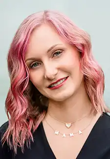 A headshot of Natalia Summerville standing in front of a light gray background